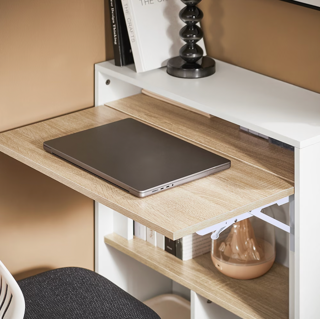 Plateau déplié du bureau pliable mural avec un ordinateur portable posé dessus